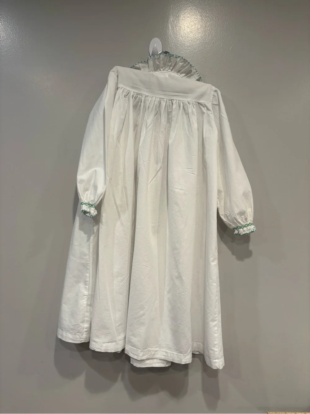 White Girls' Long Sleeve Dress with Mint Smocking Detail Hand Smocked.